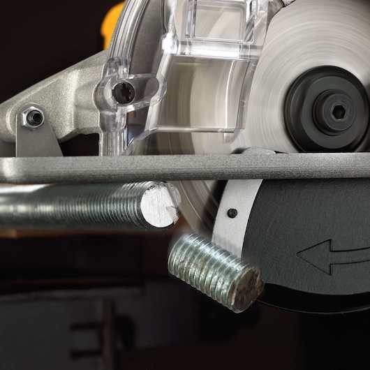 Close-up of a DEWALT metal cutting saw in operation, cutting through a threaded steel rod. The blade is spinning and making precise contact with the metal.
