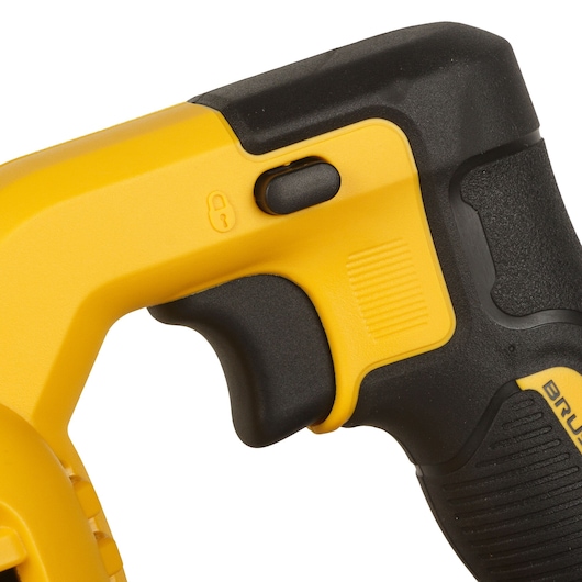 Close-up of the handle and trigger area of a yellow and black DEWALT power tool, showing a lock switch and textured grip.