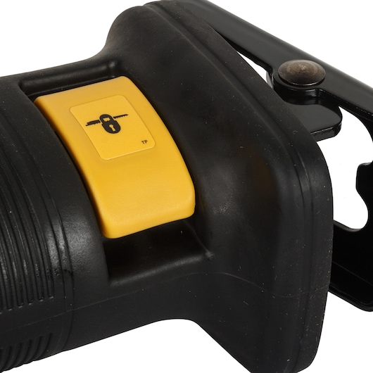 Close-up view of the yellow safety lock button on a black DEWALT power tool, showing the lock symbol and part of the tool's handle.