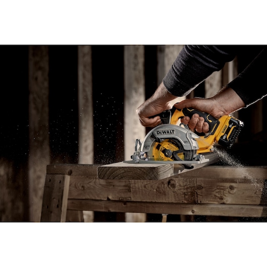 Xtreme 12 volt 5 and three eighths inch brushless cordless circular saw tool being used to cut wood.