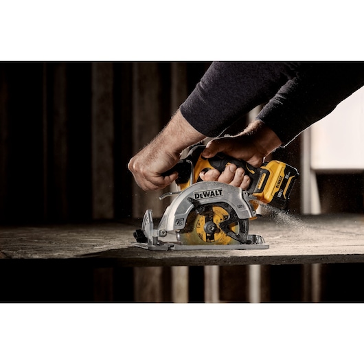 Xtreme 12 volt 5 and three eighths inch brushless cordless circular saw tool being used to cut wood.