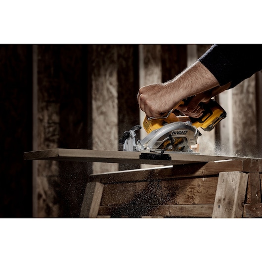 Xtreme 12 volt 5 and three eighths inch brushless cordless circular saw tool being used to cut wood.