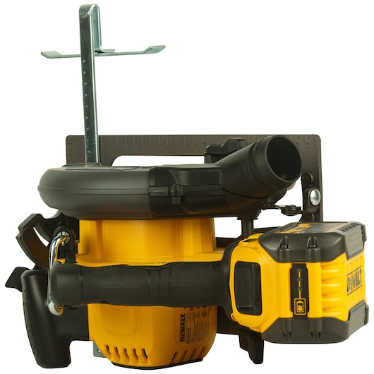 A DEWALT DCS575T2 cordless power tool with a yellow and black body, shown from the side. It features a battery pack and a dust extraction port, along with a metal guide attachment. The tool is positioned against a white background.