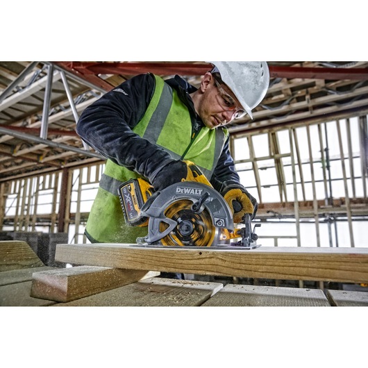 DEWALT tools in use; DCZ507T2-XE, DCS578N, DCZ503X2-XE. Construction worker cutting wood on site.