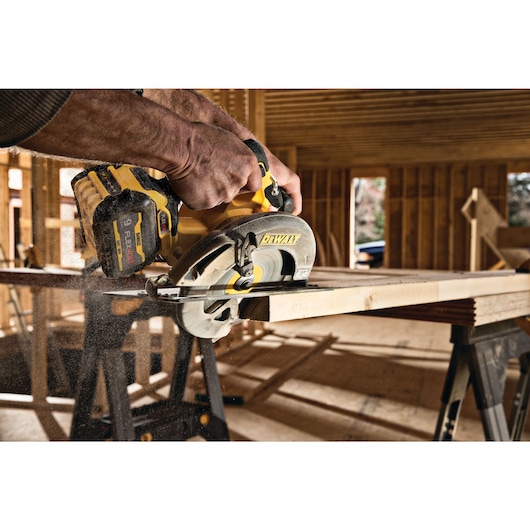 FLEXVOLT brushless cordless circular saw with brake kit cutting wood at an angle.