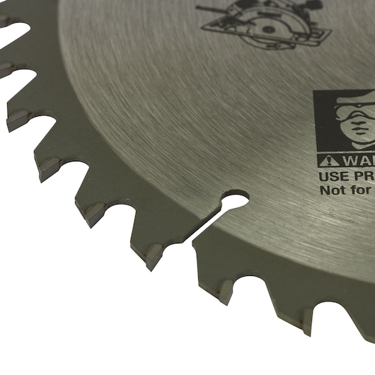 Close-up image of a DEWALT circular saw blade showing its sharp metal teeth and safety warning labels etched on the surface.