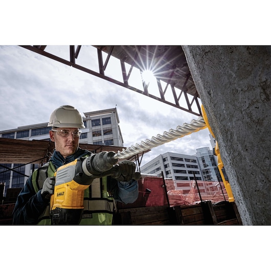 DEWALT drill in use at construction site. DT60814, DT60814-QZ SKU. Photography category.