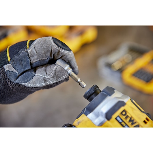 overhead shot of user in the process of putting a DEWALT Impact Screwdriver Bit into DEWALT drill