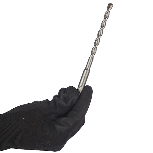 A hand wearing a black glove is holding a metal drill bit with a spiral design against a white background.