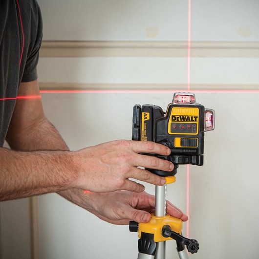 Compatible red 3 by 360 line laser being used by a person.