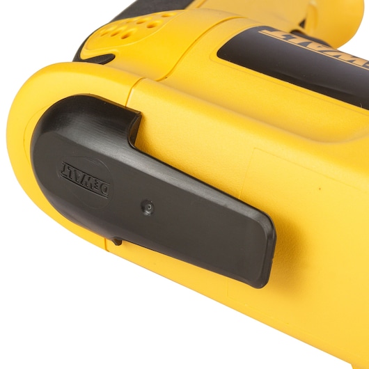 Close-up of a yellow DEWALT power tool showing the black belt clip attachment.