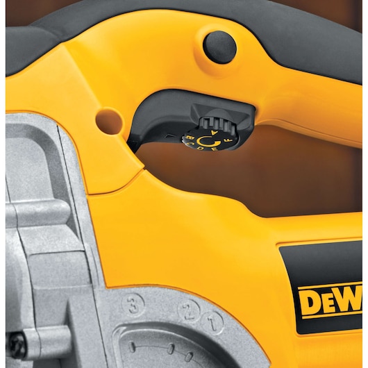 Close-up photo of the handle and control dial of a yellow DEWALT power tool, featuring black and gray accents and labeled controls.
