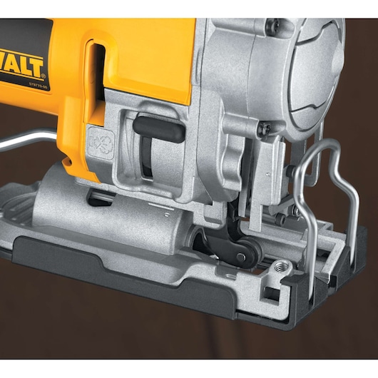 Close-up view of a DEWALT jigsaw power tool, showing its metallic base, blade mount, and part of its yellow and silver body.