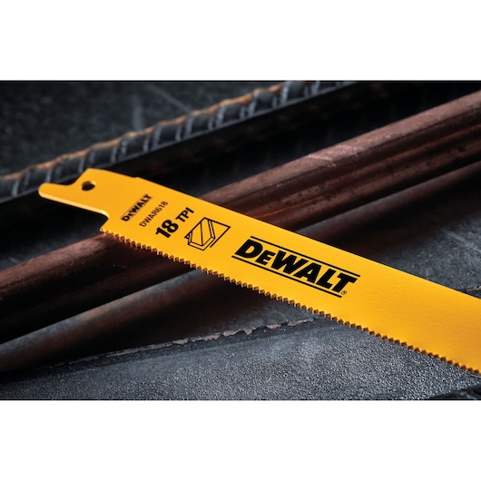 Close-up image of a yellow DEWALT reciprocating saw blade with '18 TPI' marking, placed next to metal rods.