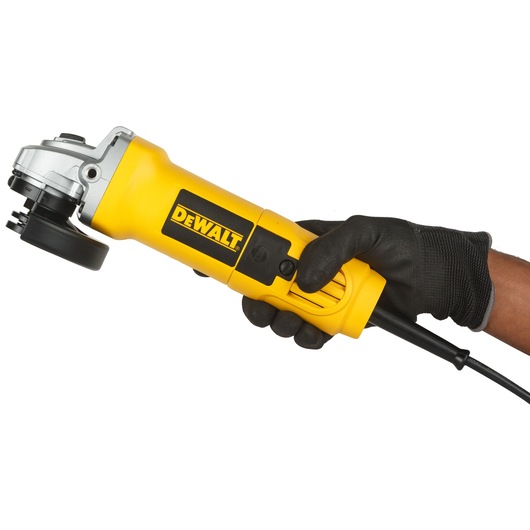 A person wearing a black glove is holding a yellow DEWALT angle grinder with a power cord.