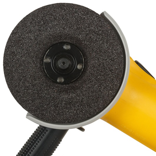 Close-up view of a DEWALT angle grinder with a black abrasive disc and yellow handle.