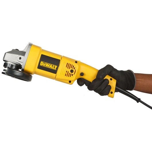 A person wearing a black glove holds a yellow DEWALT angle grinder, model DW831, against a white background.