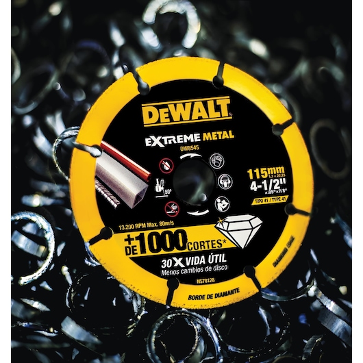 A close-up of a DEWALT Extreme Metal cutting disc, model DW8545, with yellow and black coloring. The disc is labeled for metal cutting, with specifications including 115mm diameter, 4-1/2 inches, maximum speed 13,200 RPM. Graphics indicate its use for cutting metal pipes and bars. The background features metal shavings.