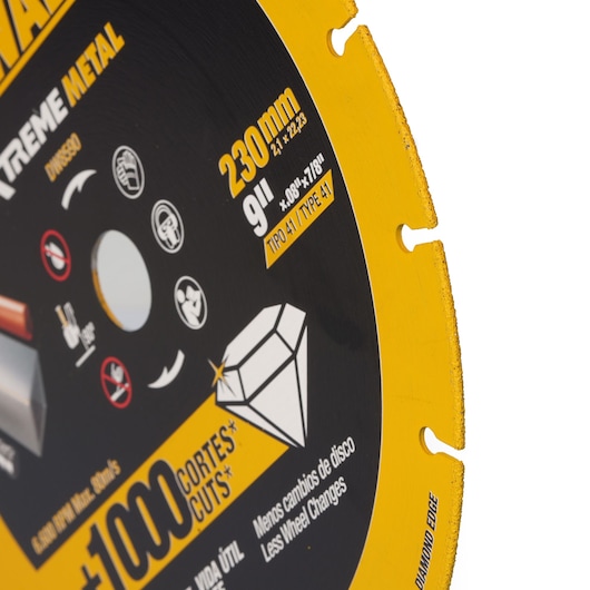Close-up of a DEWALT diamond metal cutting disc, 230mm size, featuring product information such as 'diamond edge', '+1000 cuts', and various icons and specifications printed on the disc.