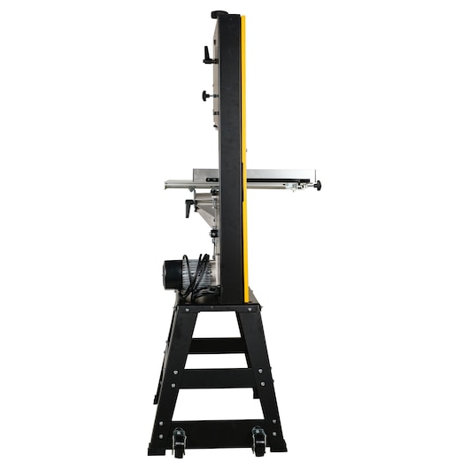 Side view of a DEWALT industrial band saw machine, showing its sturdy metal frame, motor, and adjustable work table.