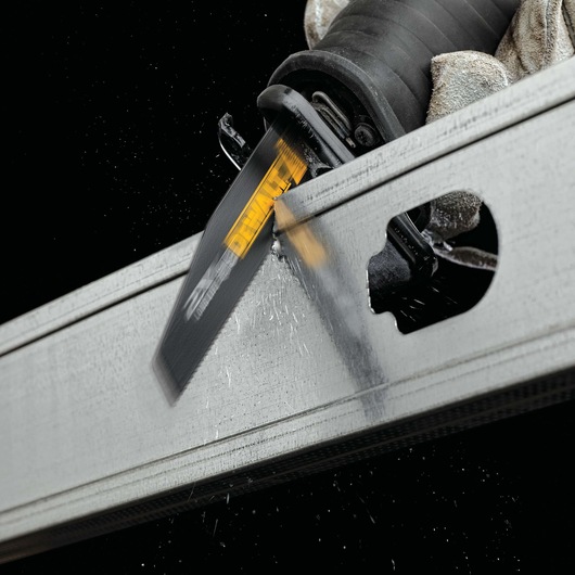 Photo of DEWALT DWA4176 reciprocating saw blade cutting metal, close-up with sparks, product in action.