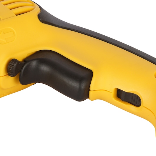 Close-up view of the handle and trigger area of a yellow and black DEWALT power tool, showing ergonomic grip and control switches.