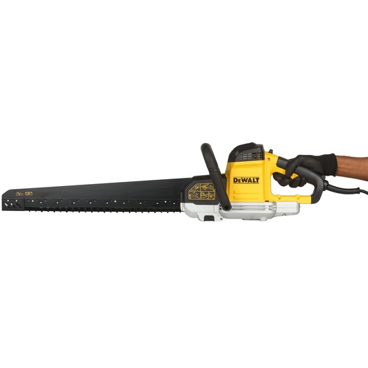 A DEWALT electric saw with a long black blade and yellow housing, being held by a gloved hand.