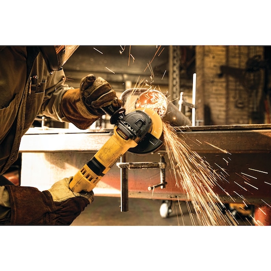 High performance trigger switch grinder with nolock on being used at a construction site.