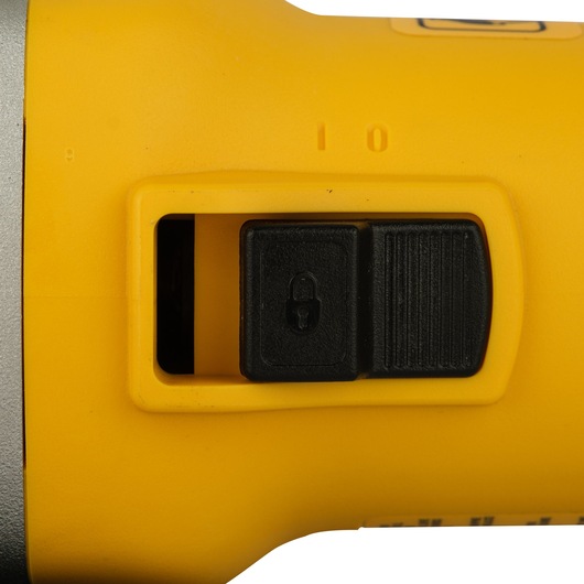 Close-up of a DEWALT power tool showing a black switch on a yellow casing, with a lock symbol visible on the switch.