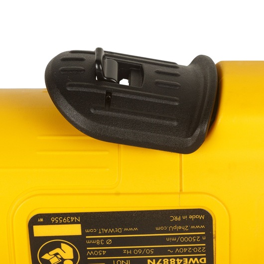 Close-up view of a yellow DEWALT power tool showing a black plastic shield and a product information label with model number DWE4887N.