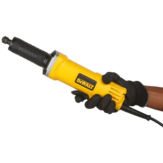 A person wearing black gloves is holding a yellow DEWALT electric die grinder against a white background.