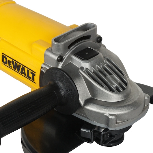 Close-up view of a DEWALT branded angle grinder with a yellow body and black handle, showing metallic housing and ventilation slots.