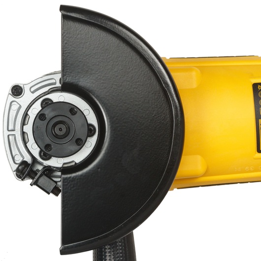 Close-up view of a DEWALT angle grinder showing the metal protective guard and part of the yellow body.