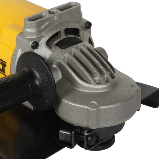 Close-up view of a DEWALT angle grinder showing the handle and motor housing, with a focus on the metal casing and vents.