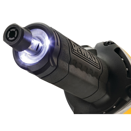 Close-up view of the front end of a DEWALT power tool, showing a lit LED ring around the spindle for improved visibility during operation.