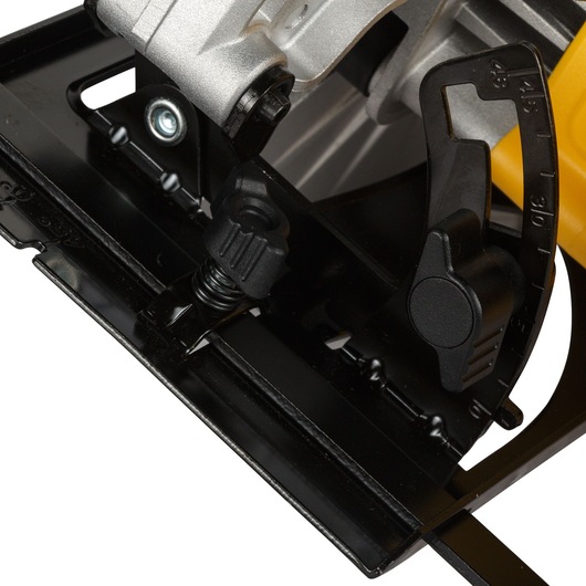 Close-up view of a DEWALT circular saw base, showing the angle adjustment mechanism and black metal components.