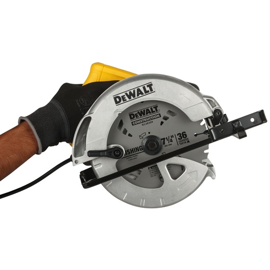 A close-up image of a DEWALT DWE561A circular saw, held by a person wearing a black work glove. The saw features a silver blade guard and visible DEWALT branding.