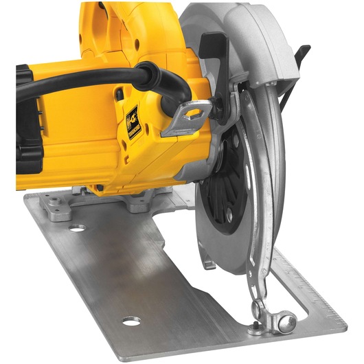 Close-up view of a DEWALT circular saw, model DWE575, showing the blade guard, metal base plate, and power cord.