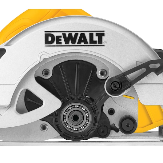 Close-up view of a DEWALT circular saw, focusing on the blade housing and mechanical components. The DEWALT logo is prominently displayed on the metallic guard.