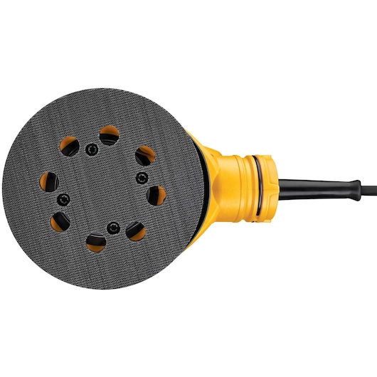 Close-up view of a DEWALT DWE6423 yellow and black electric orbital sander, showing the round sanding pad with ventilation holes and attached power cord.