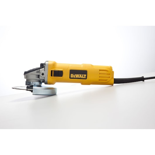 A yellow DEWALT angle grinder with a black power cord is displayed on a white surface.
