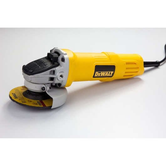 A yellow DEWALT angle grinder with a black power cord, shown on a white surface.