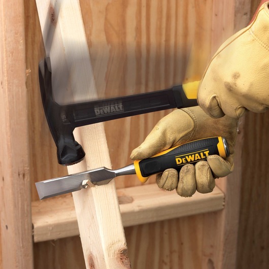 Side Strike Chisel being struck with hammer to scrape wooden surface.