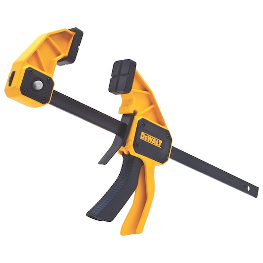 A yellow and black DEWALT trigger clamp with a pistol-grip handle and adjustable jaws, designed for holding materials securely in place during woodworking or other projects.