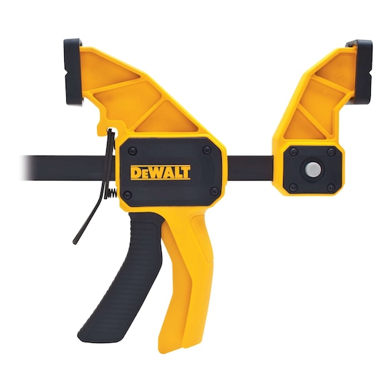 A DEWALT branded yellow and black quick grip bar clamp with ergonomic handle, designed for holding materials securely during woodworking, assembly, or photography projects.