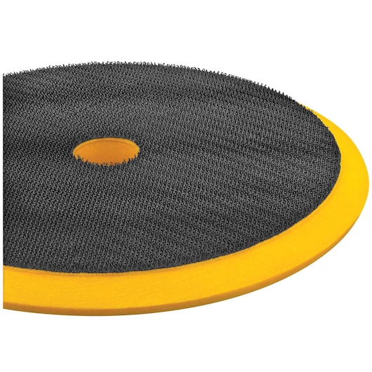 Close-up view of a DEWALT circular polishing pad with a textured black surface and a central hole, featuring a yellow foam backing.