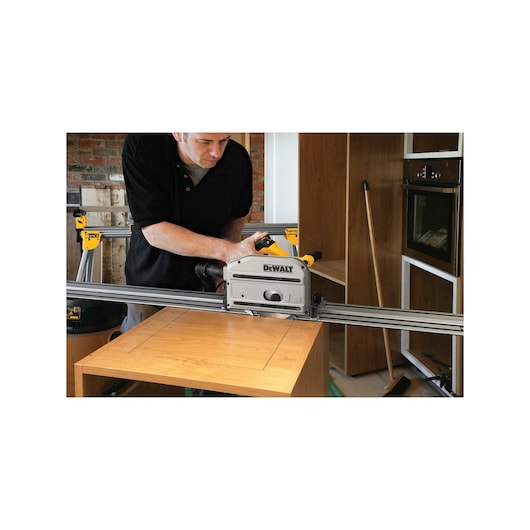 track saw kit being used by a person to cut wood.