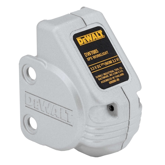 A DEWALT DWS7085 XPS Worklight attachment, shown in close-up. The light grey device features mounting holes and a DEWALT logo embossed on the side. The black and yellow label displays the model details and specifications.
