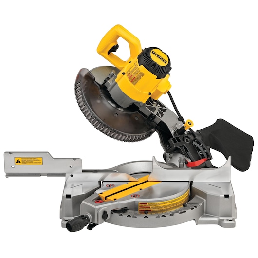 A DEWALT DWS713 compound miter saw with yellow and black accents, featuring a circular blade and adjustable base for precise angled cuts. The saw is positioned at an angle, showing safety labels and ergonomic handles.