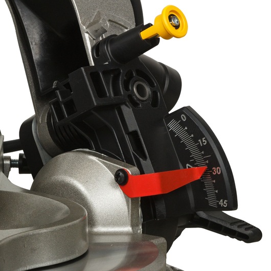 Close-up view of the DEWALT DWS715 miter saw showing the angle adjustment gauge with a red indicator and a yellow knob. The gauge displays angles for precise cutting.